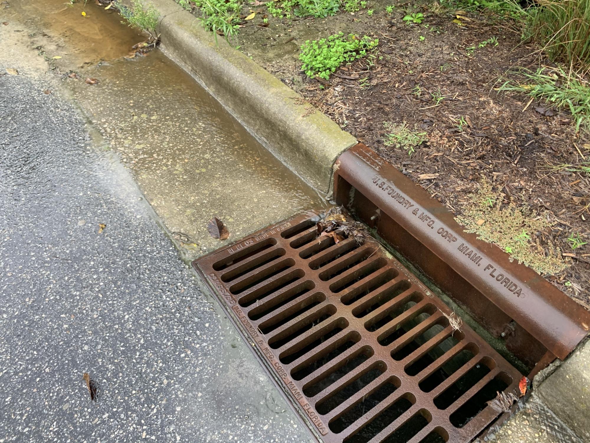 Stormwater flowing down curb into drop inlet 