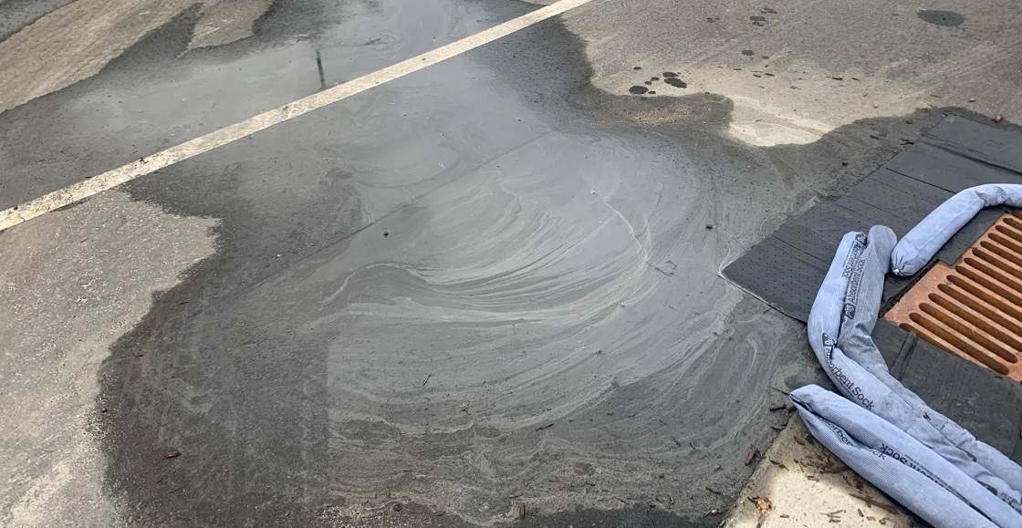 Photo of concrete slurry discharging into storm drain inlet.