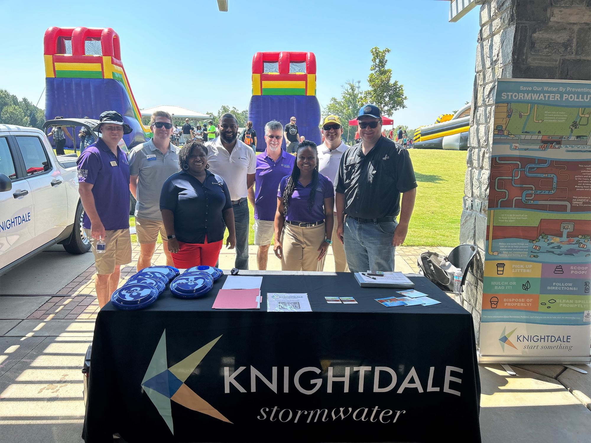 Council Members and staff at K-Fest in front of stormwater education booth