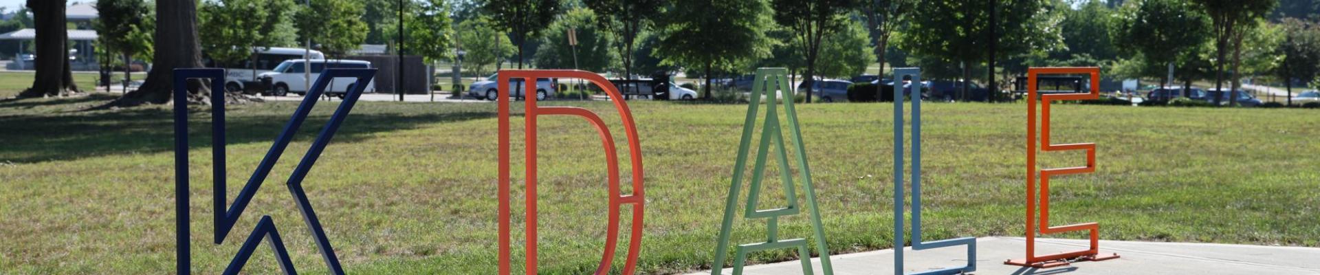 Bike rack made of letters that spell KDALE.