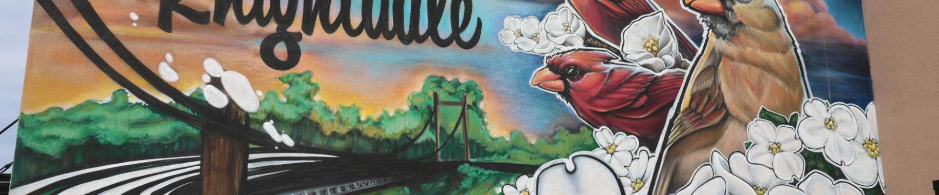 Mural with a cardinal and flowers that says "Welcome to Knightdale"